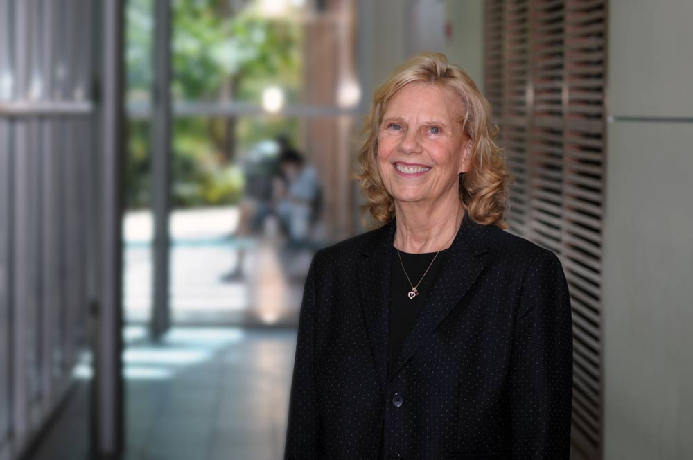 A three quarter informal portrait of Katharine Cole in a hallway on campus